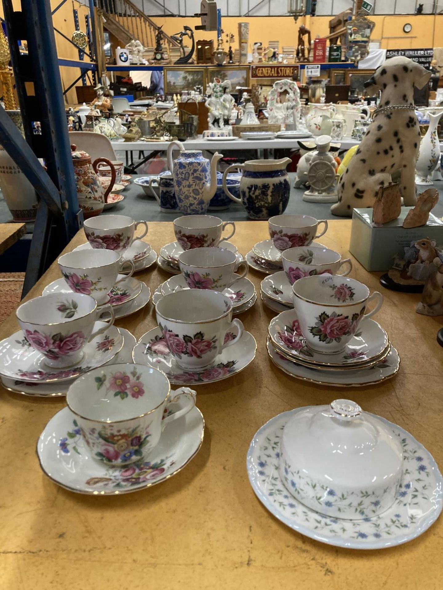 A QUANTITY OF BONE CHINA 'ROSE' PATTERNED TRIOS PLUS A COALPORT 'JUNETIME' CUP AND SAUCER AND A