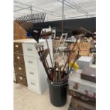 A DUSTBIN CONTAINING AN ASSORTMENT OF GARDEN TOOLS TO INCLUDE FORKS, BRUSHES AND SHEARS ETC