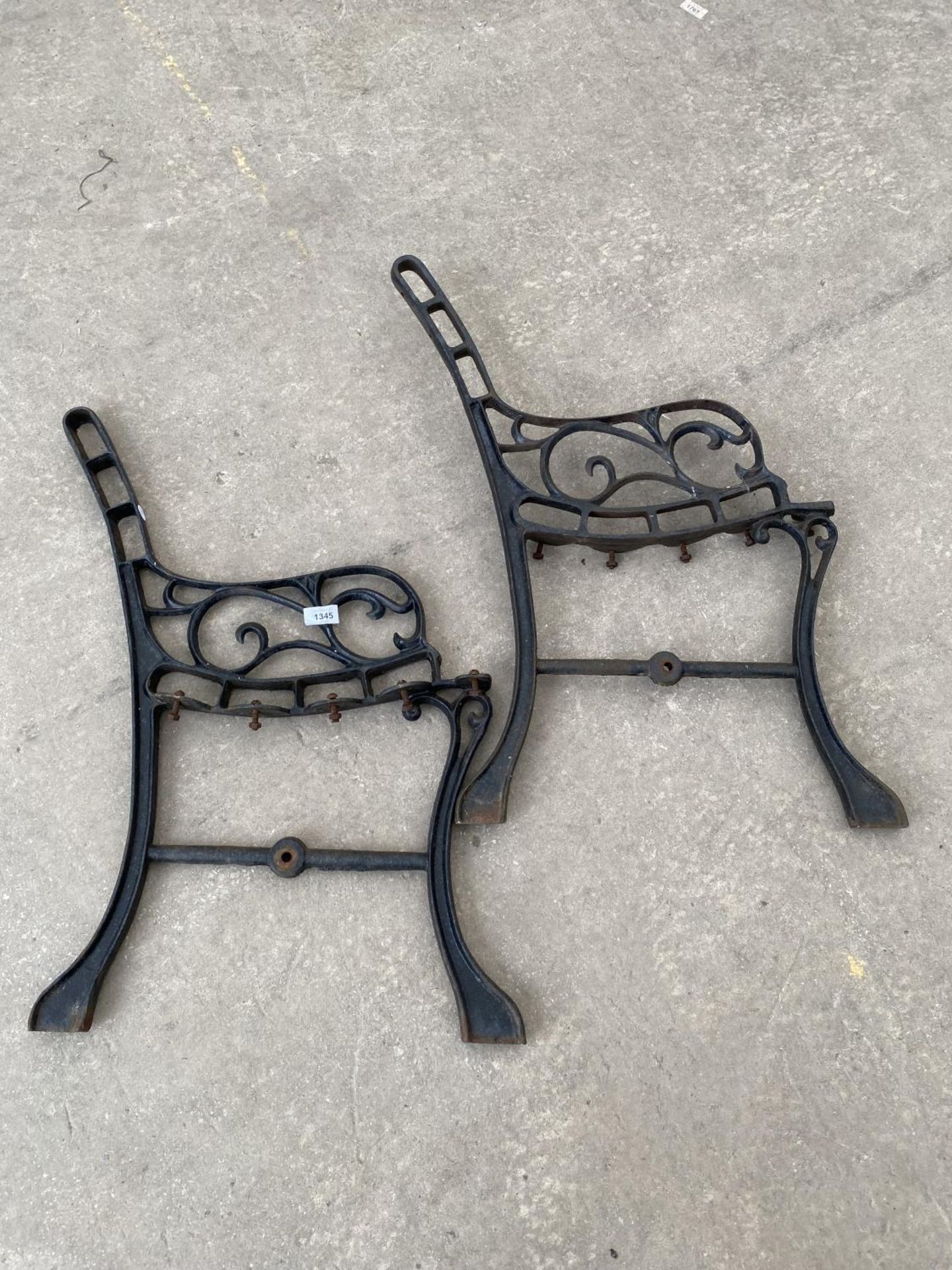 A PAIR OF DECORATIVE CAST IRON BENCH ENDS
