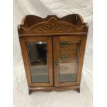 AN ARTS & CRAFTS STYLE OAK SMOKER'S CABINET WITH GLASS DOORS AND DRAWERS