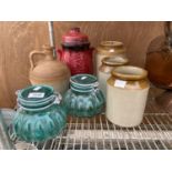 AN ASSORTMENT OF GLASS AND STONEWARE POTS AND JARS