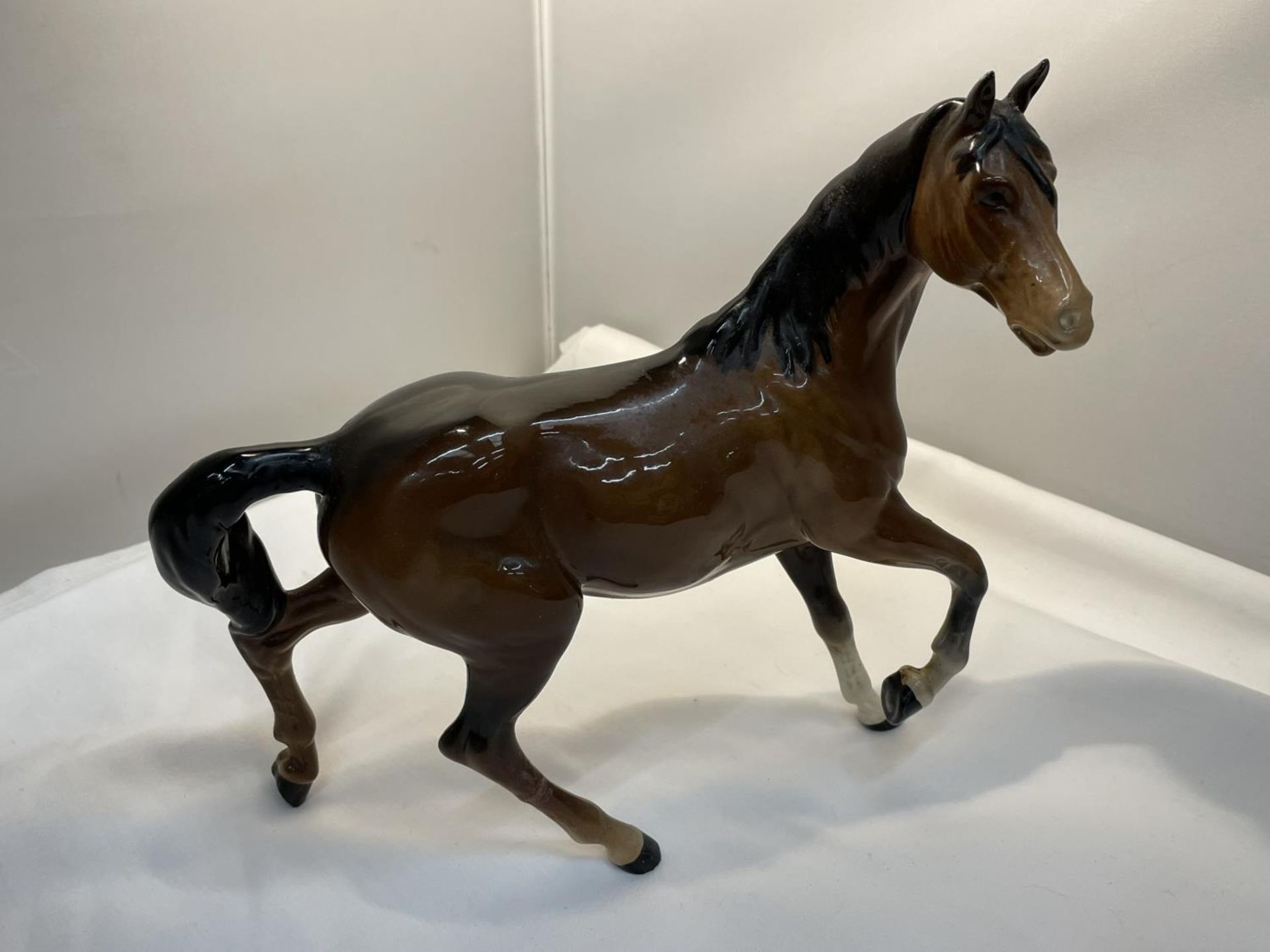 A ROYAL DOULTON GLOSS BAY PRANCING HORSE