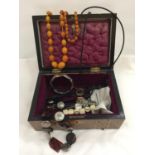 A MAHOGANY MARQUETRY DOMED LID BOX TO CONTAIN A BUTTERSCOTCH AMBER NECKLACE AND BRACELET, NECKLACES,