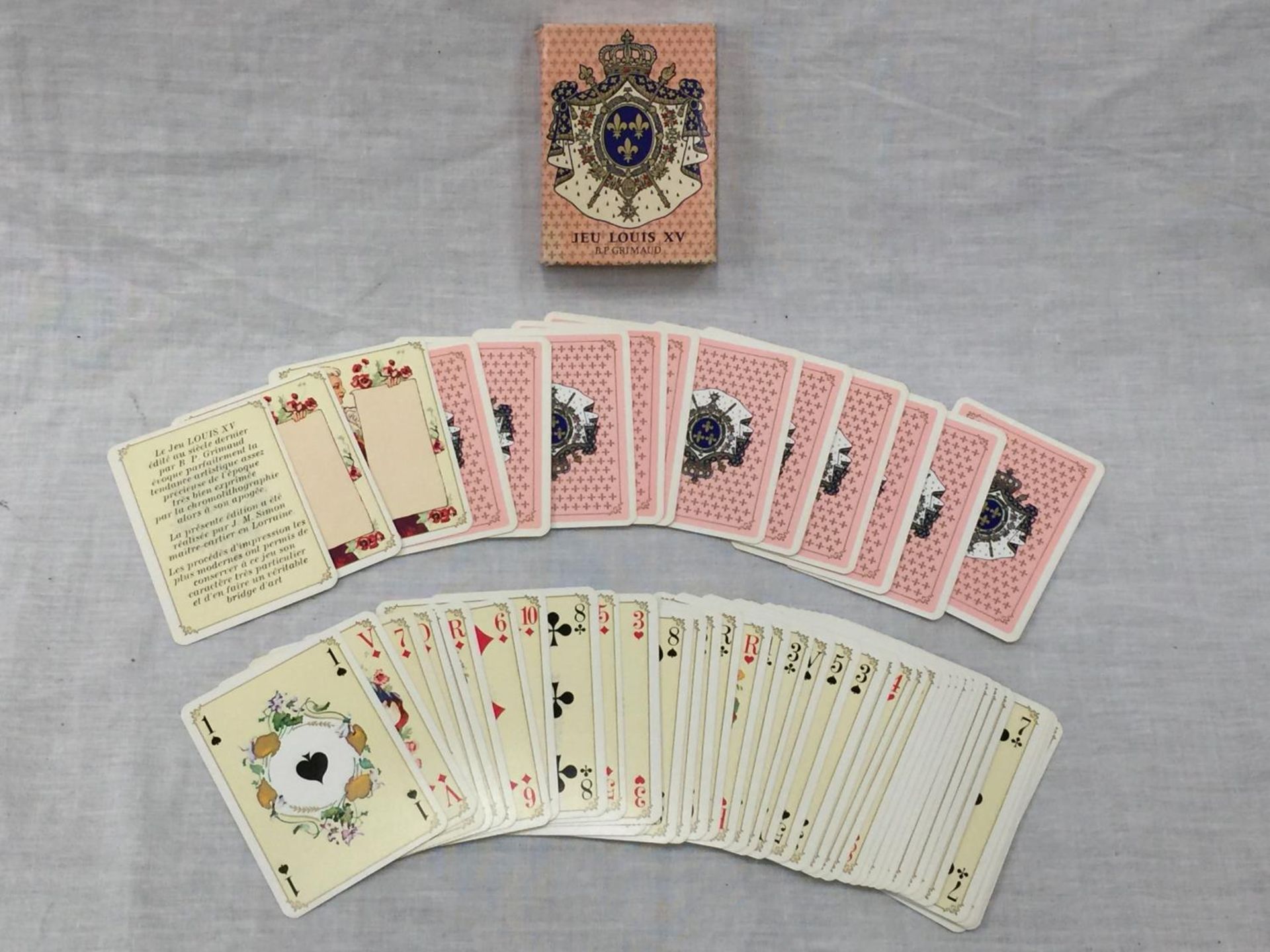 AN ANTIQUE HAND TINTED SET OF B.P. GRIMAUD JEU LOUIS XV PLAYING CARDS