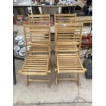 A SET OF FOUR NEW TEAK FOLDING GARDEN CHAIRS