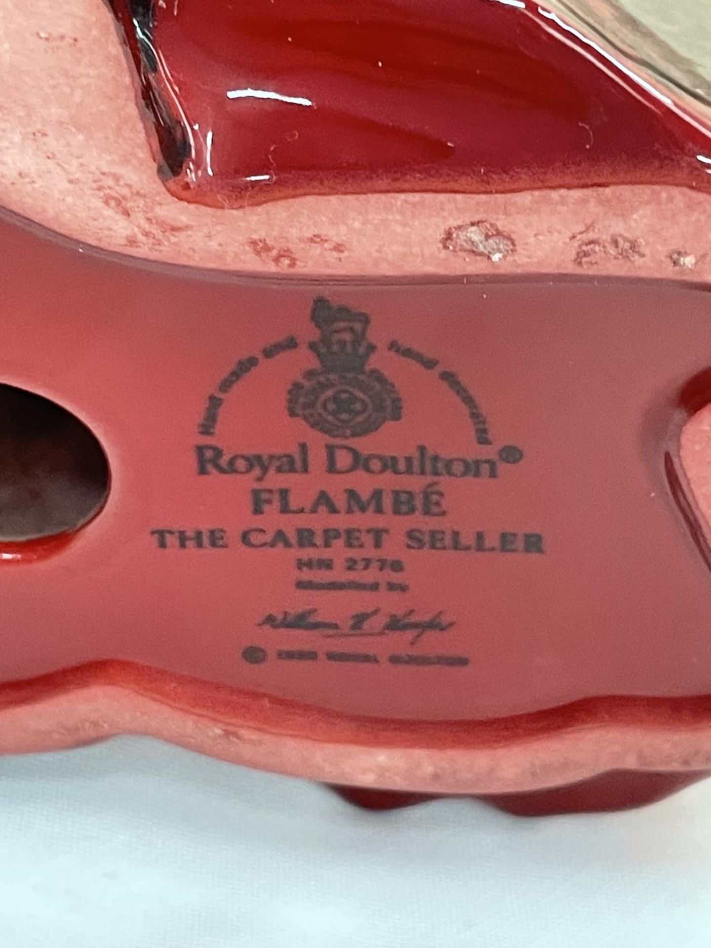 A ROYAL DOULTON FLAMBE FIGURE THE CARPET SELLER - Image 4 of 4