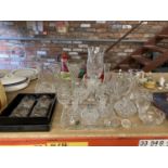 A LARGE QUANTITY OF CUT GLASS CRYSTAL TO INCLUDE VASES, JUGS, A DRESSING TABLE SET, BOXED