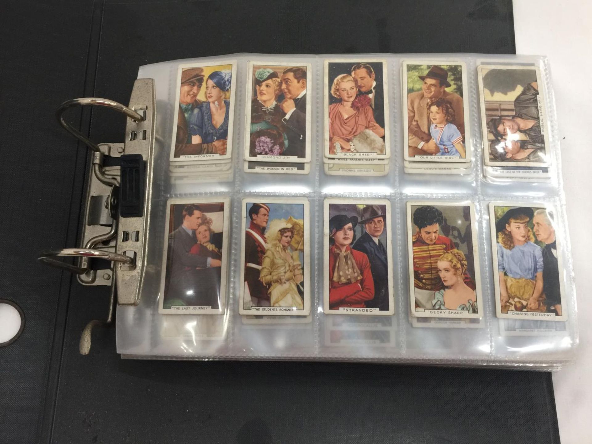 A BLACK FILE CONTAINING A QUANTITY OF CIGARETTE CARDS TO INCLUDE FILM STARS, R.A.F. BADGES, DOGS,