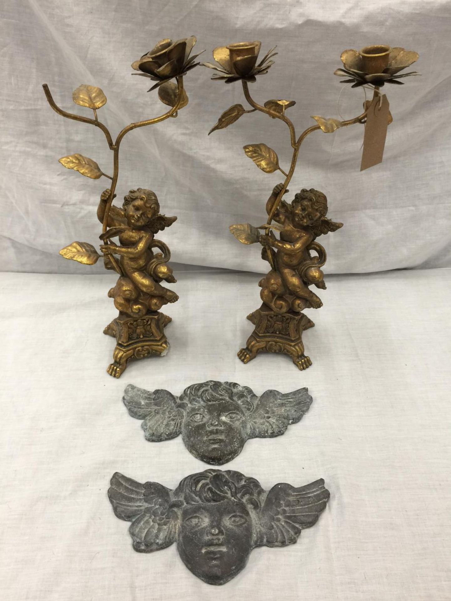 A PAIR OF DECORATIVE CANDLE STICK HOLDERS WITH CHERUB DESIGN (ONE A/F) AND TWO HEAVY CHERUB LEAD