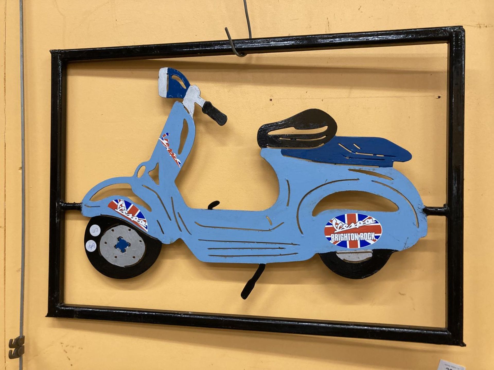 A METAL VESPA SCOOTER IN A METAL FRAME 44CM X 63CM