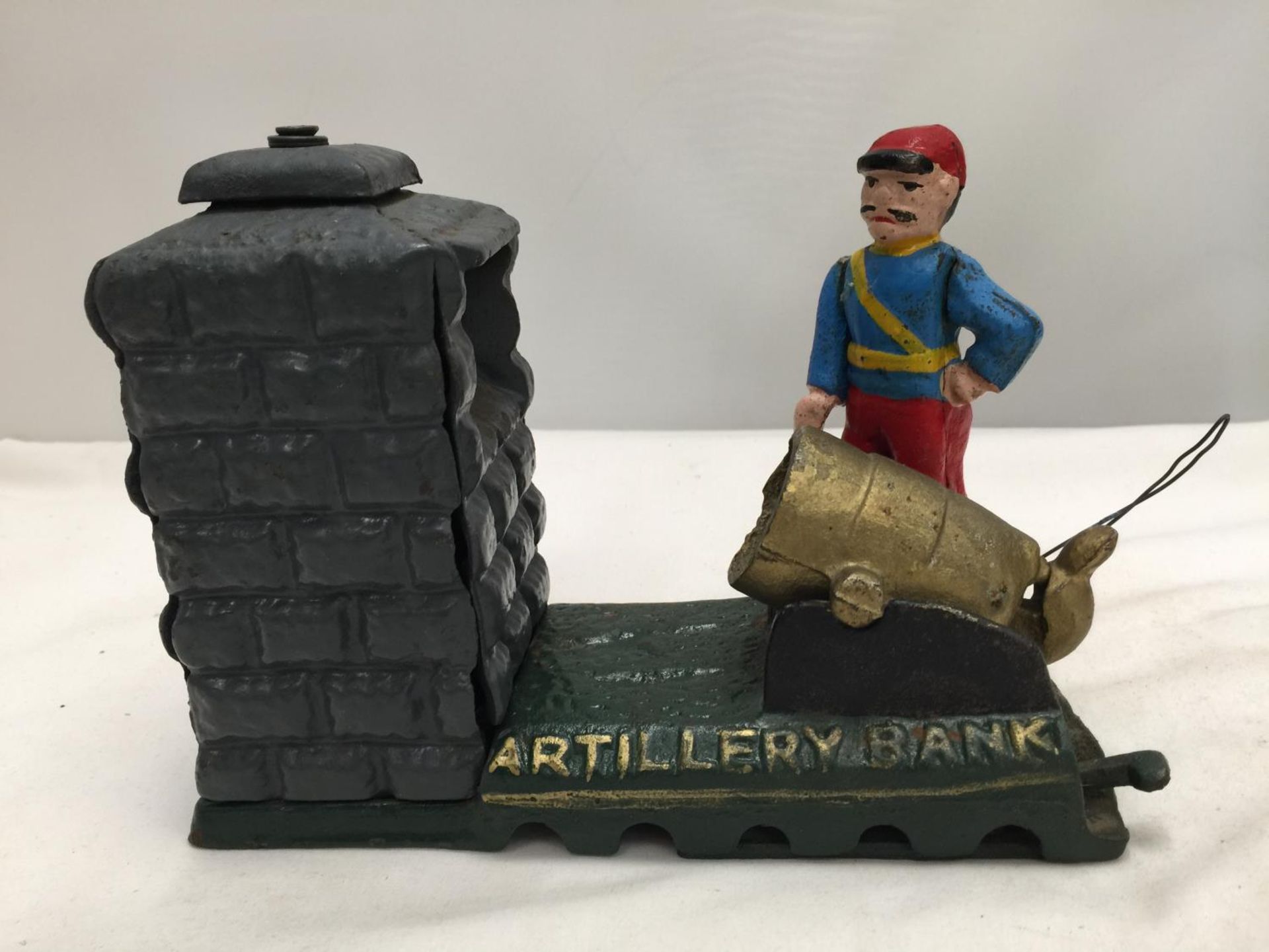 A VINTAGE STYLE CAST MONEY BOX OF A SOLDIER WITH A CANNON