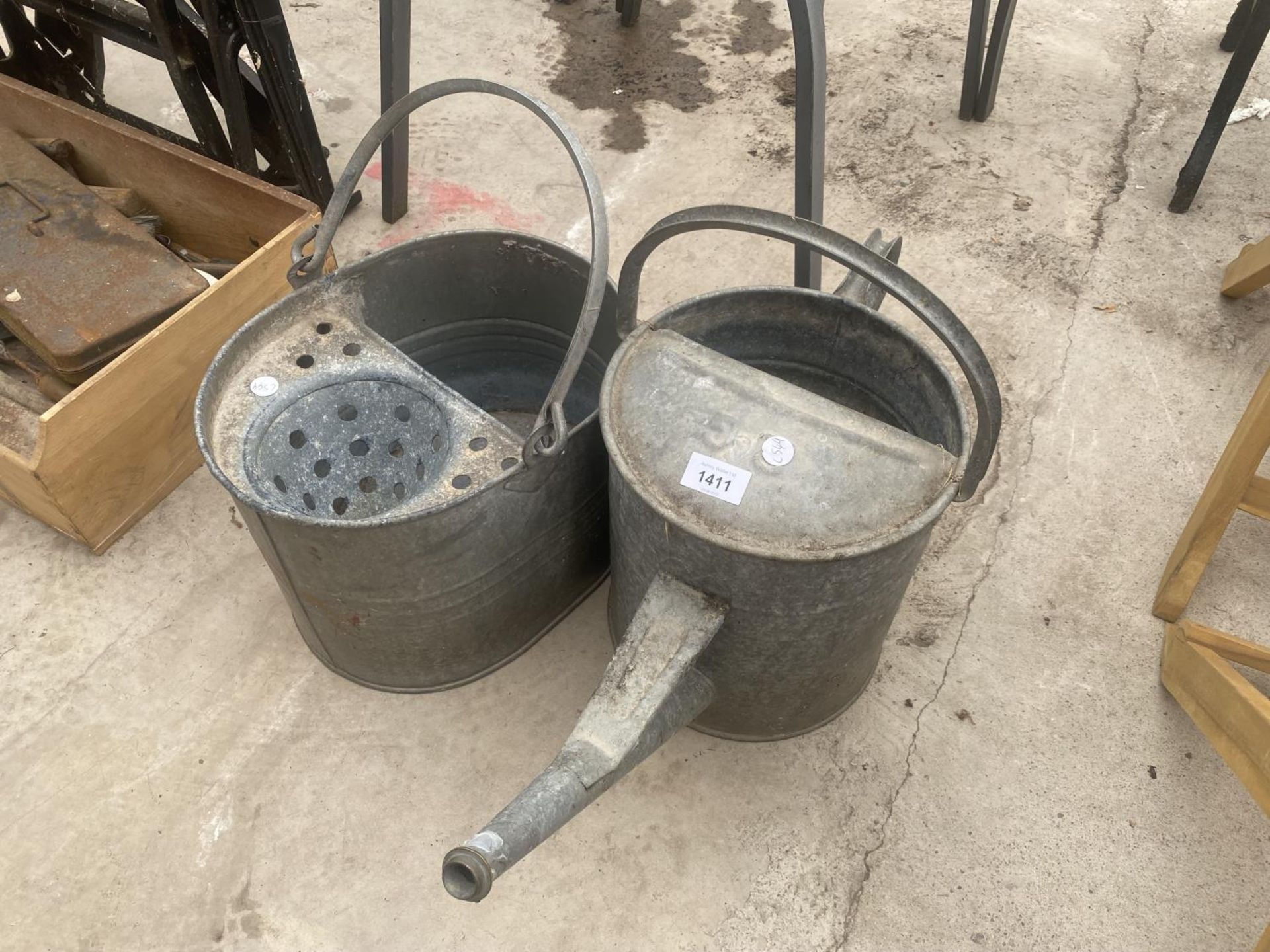 A GALVANISED MOP BUCKET AND A GALVANISED WATERING CAN