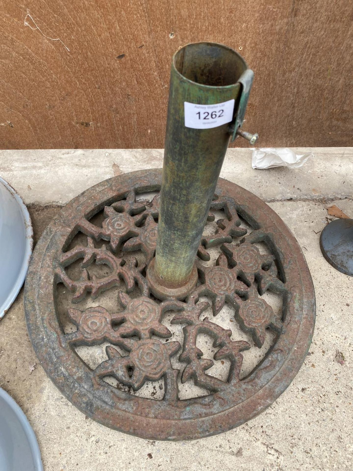 A VINTAGE CAST IRON PARASOL BASE WITH FLORAL DESIGN