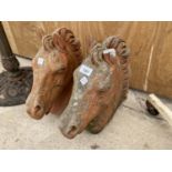 A PAIR OF RECONSTITUTED STONE HORSE HEADS (ONE EAR A/F)