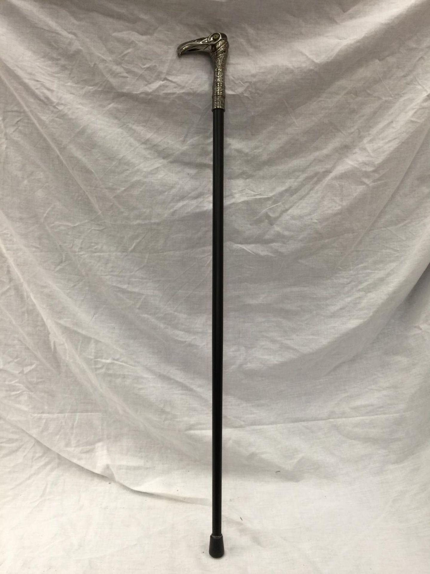 A WALKING STICK WITH AN EAGLES HEAD HANDLE