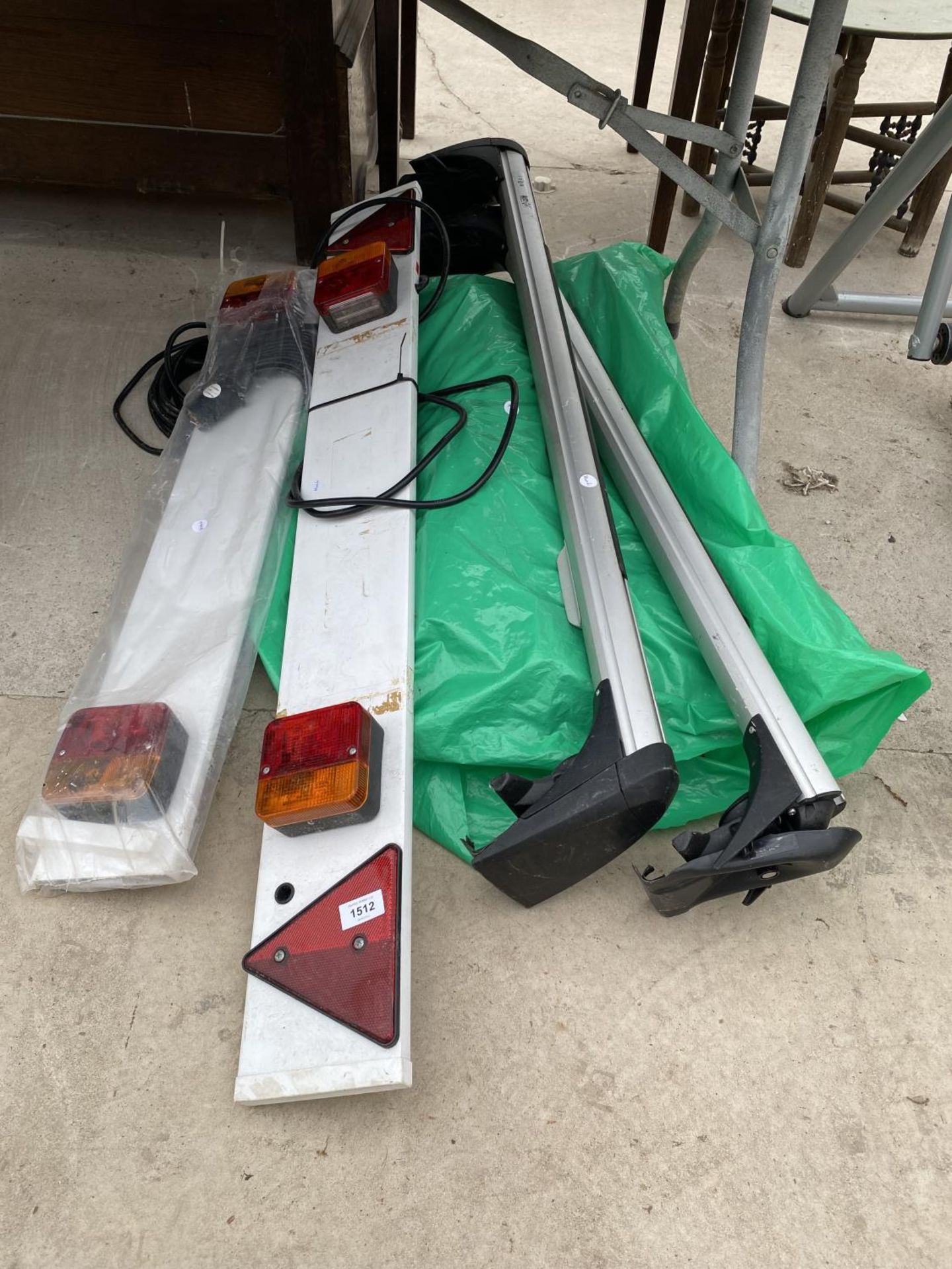 A SET OF TWO CAR ROOF BARS AND TWO TRAILER LIGHT BOARDS