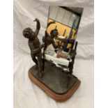 A VINTAGE FRENCH BRONZED FIGURE OF A BOY AND A TRELLIS OF FLOWERS SUPPORTING A MIRROR (MIRROR NOT