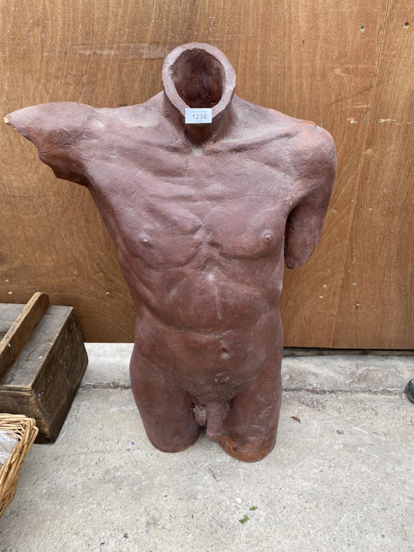 A PAINTED RECONSTITUTED STONE MALE TORSO