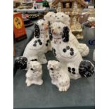 A PAIR OF BLACK AND WHITE STAFFORDSHIRE STYLE SPANIELS, A PAIR OF WHITE AND A SMALLER PAIR