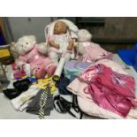 A QUANTITY OF CHILDREN'S AND DOLLS CLOTHES PLUS TEDDIES AND A DOLL ON A CHAIR