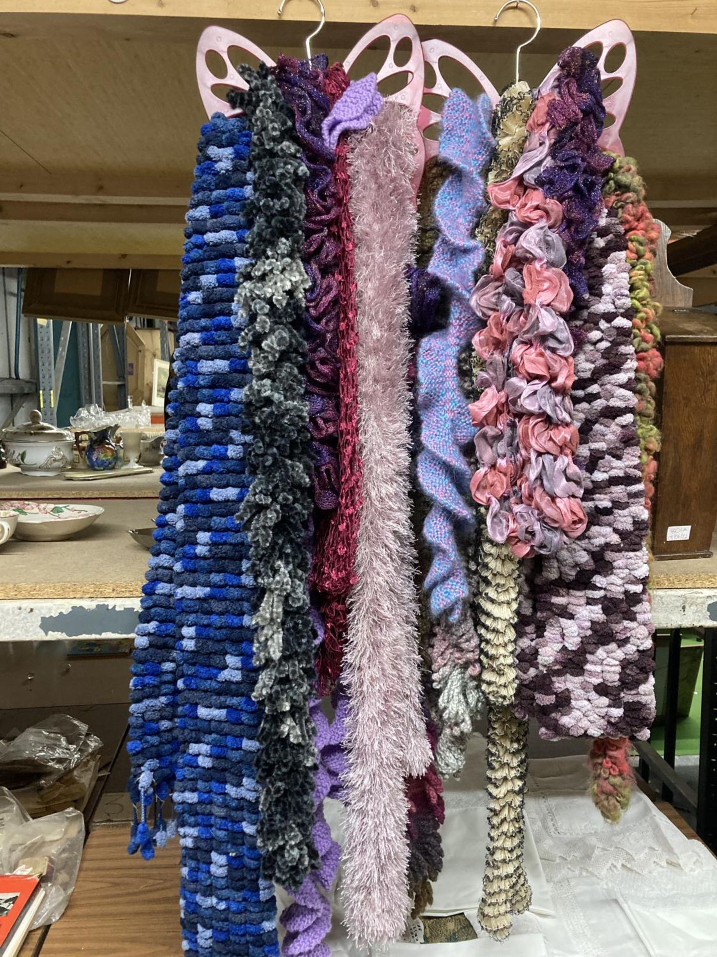 A LARGE QUANTITY OF SCARVES ON BUTTERFLY HANGERS
