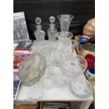 AN ASSORTMENT OF GLASS WARE TO INCLUDE A VASE, DECANTORS AND BOWLS ETC