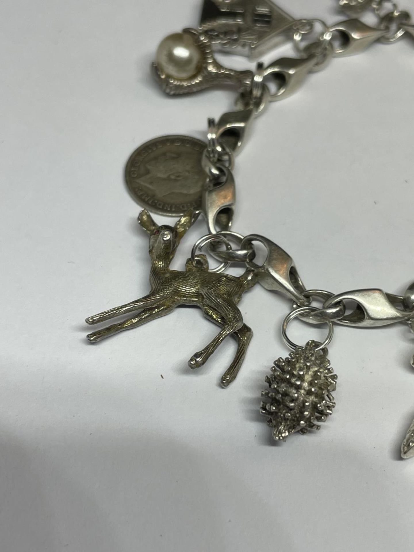 A MARKED SILVER CHARM BRACELET WITH TEN CHARMS TO INCLUDE A HEDGEHOG, SHOE, DOG, TELEPHONE ETC - Image 2 of 4