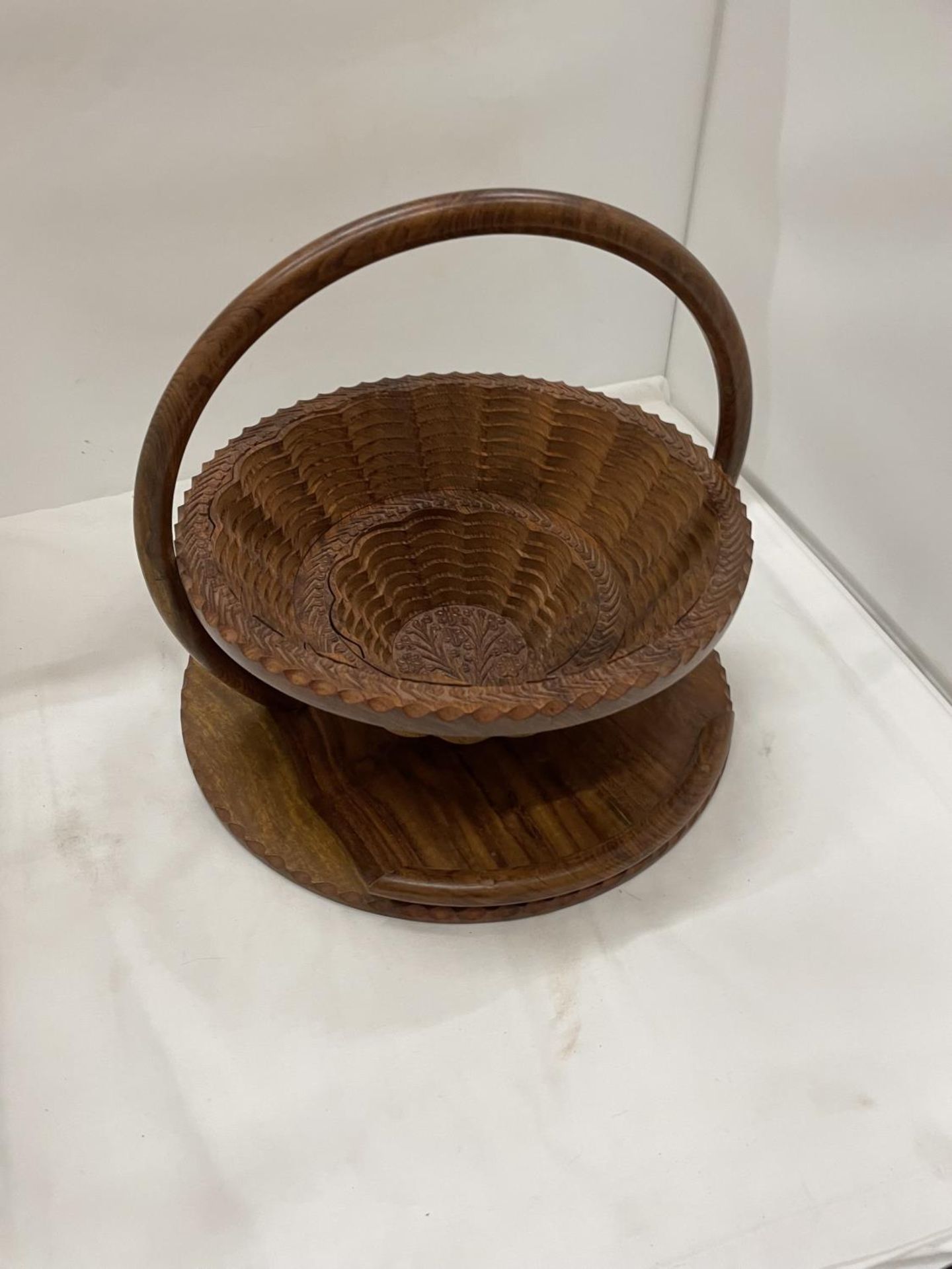 A METAMORPHIC WOODEN TRAY, PULL THE HANDLE UP AND IT BECOMES A BASKET