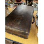 A VINTAGE LEATHER SUITCASE IN NEED OF RESTORATION