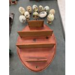 A WOODEN DISPLAY SHELF WITH A QUANTITY OF PAINTED EGGS