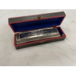 A BOXED HOHNER 'THE SUPER CHROMONICA' HARMONICA