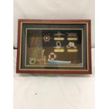 A BOX FRAME CONTAINING A MONTAGE OF MODEL NAUTICAL RELATED ITEMS