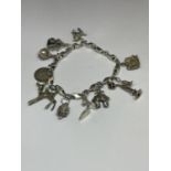 A MARKED SILVER CHARM BRACELET WITH TEN CHARMS TO INCLUDE A HEDGEHOG, SHOE, DOG, TELEPHONE ETC