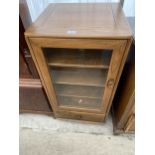 AN ERCOL MUSIC CENTRE CABINET WITH GLASS DOOR AND DRAWER TO THE BASE, 19.5" WIDE