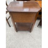 AN EARLY 20TH CENTURY OAK SEWING BOX/TABLE WITH CANTED CORNERS