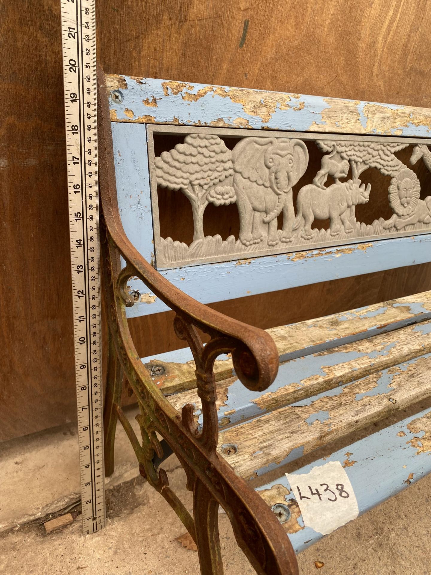 A SMALL WOODEN SLATTED CHILDRENS BENCH WITH CAST ENDS AND PLASTIC SAFARI BACK - Image 4 of 4