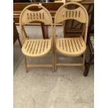 A PAIR OF FOLDING CHAIRS WITH SLATTED SEATS AND BACKS