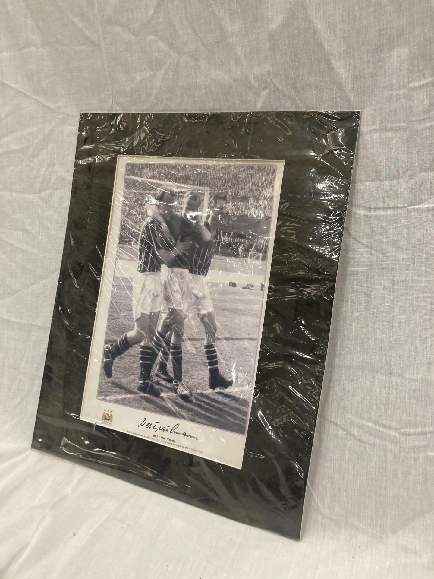 A SIGNED BERT TRAUTMAN PICTURE OF HIM BEING HELPED LEAVING THE PITCH AT WEMBLEY AFTER PLAYING THE - Image 2 of 5