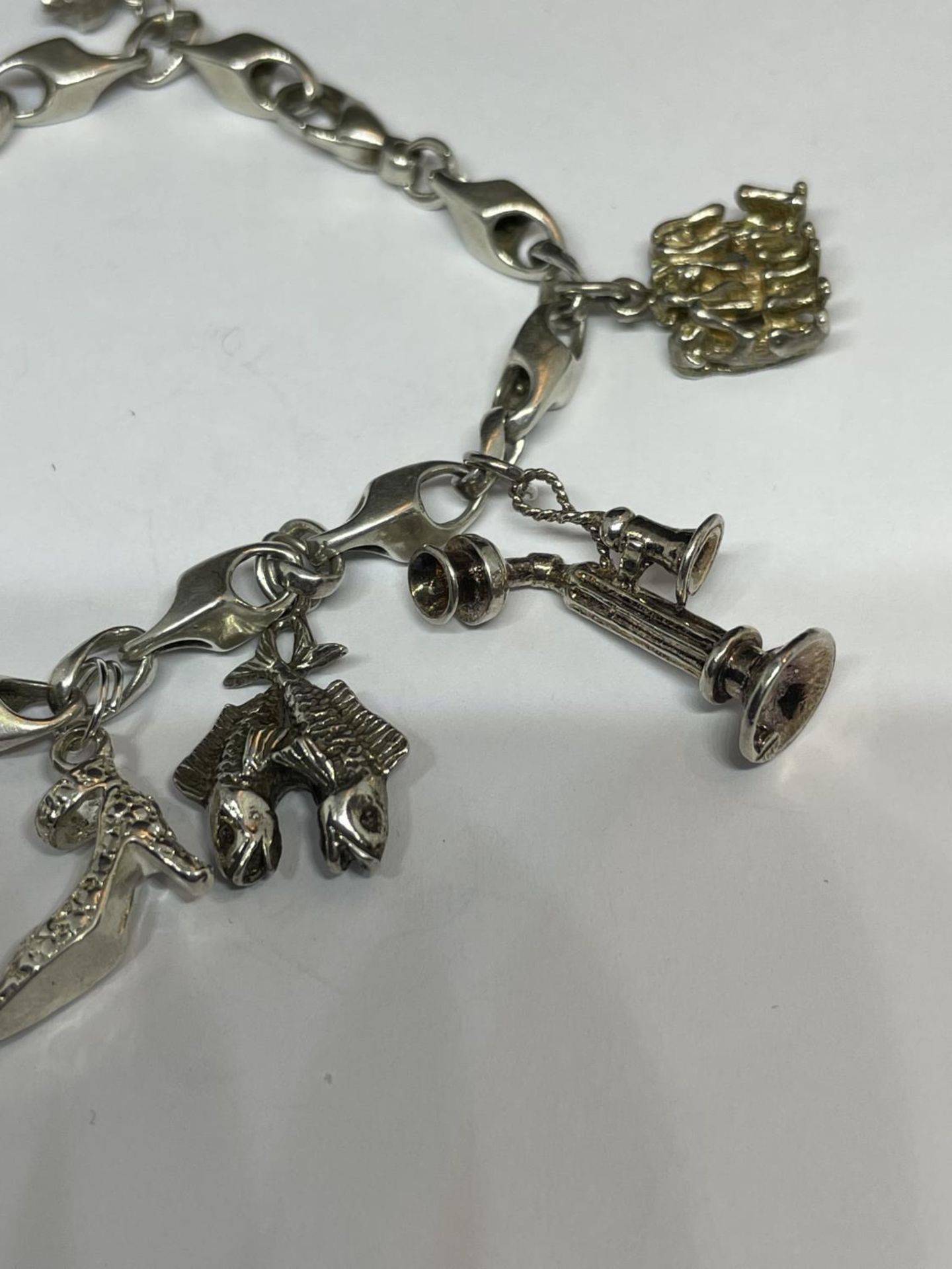 A MARKED SILVER CHARM BRACELET WITH TEN CHARMS TO INCLUDE A HEDGEHOG, SHOE, DOG, TELEPHONE ETC - Image 4 of 4