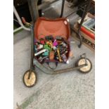 A VINTAGE CHILD'S SCOOTER AND A 'TRUNKI' CONTAINING TRUCKS, CARS, TRAINS, ETC