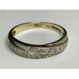 A 9 CARAT GOLD RING WITH DIAMONDS IN A CROSSOVER DESIGN SIZE L/M