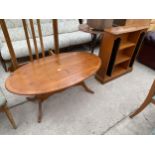 AN OVAL YEW WOOD COFFEE TABLE AND BOOKCASE/CD RACK