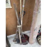 AN ASSORTMENT OF VINTAGE TOOLS TO INCLUDE A CHIMNEY SWEEP, PICK AXE AND RAKE ETC