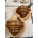 A PAIR OF WALL HANGING WOODEN BOWLS WITH ACORN DECORATION