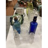 A QUANTITY OF GLASSWARE TO INCLUDE DESSERT GLASSES VASES, VINTAGE BOTTLES, ETC