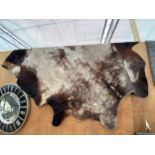 A LARGE COW HIDE RUG
