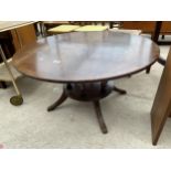 A MAHOGANY AND CROSSBANDED TWO TIER COFFEE TABLE ON SIX TURNED COLUMNS WITH SPLAY BASE, 36" DIAMETER