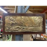A BRASS AND MAHOGANY ART DECO STYLE PLAQUE 48CM X 24CM