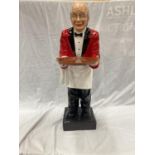 A DUMB WAITER DEPICTING A BUTLER IN A RED JACKET WITH A TRAY HEIGHT 96CM