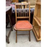 AN EDWARDIAN OAK AND BEECH FOLDING CHILDS CHAIR WITH SPINDLE BACK